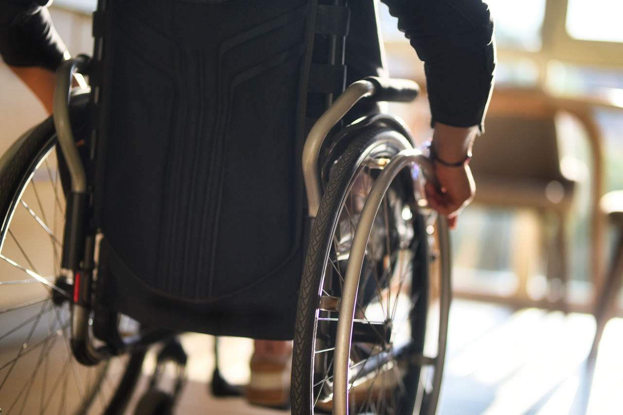 Active living with a disability: a woman moving around in a wheelchair indoors